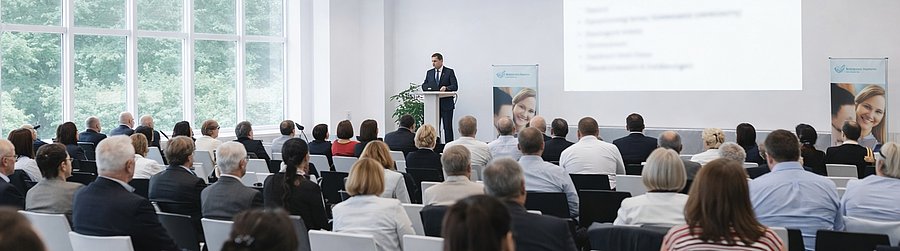 Foto einer Veranstalung des KCGs, Referent vor Publikum